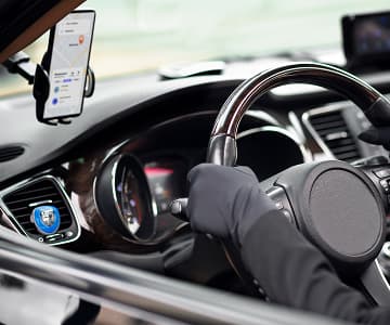 A nice car with a driver that using a smartphone app
